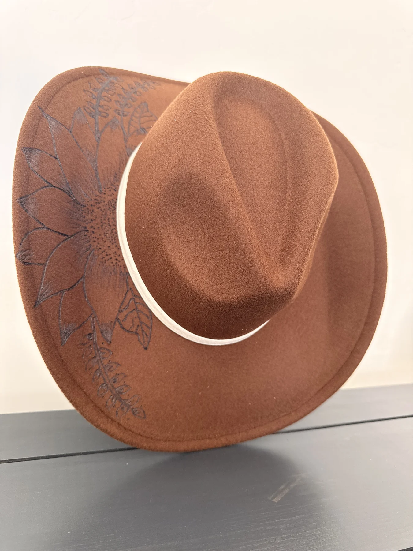 Full rust brown wide-brim hat with sunflower etching