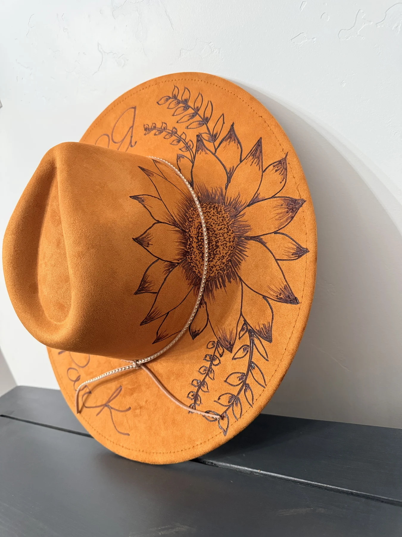 Golden amber hat with sunflower and script etching by Alicia Montoya